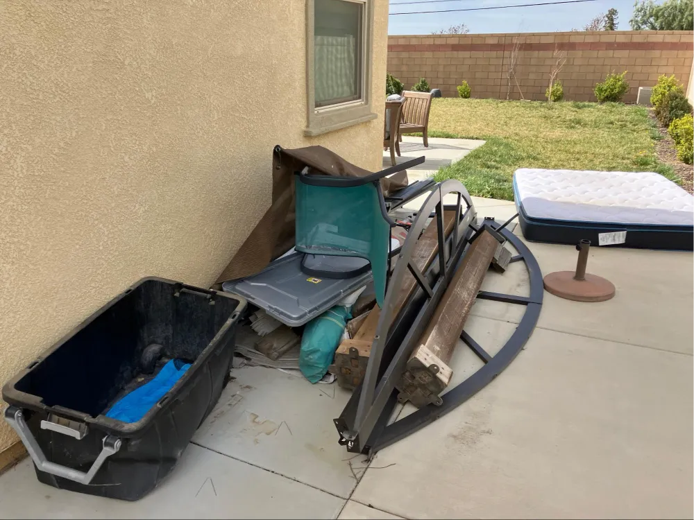 Pile of junk, boxes, and discarded items from a property clean-out.