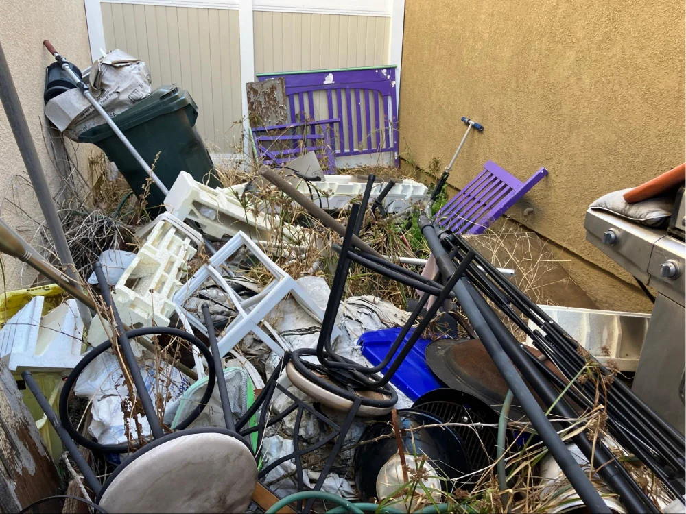 Variety of items and junk gathered during a property cleanout service by Dumpmasters.