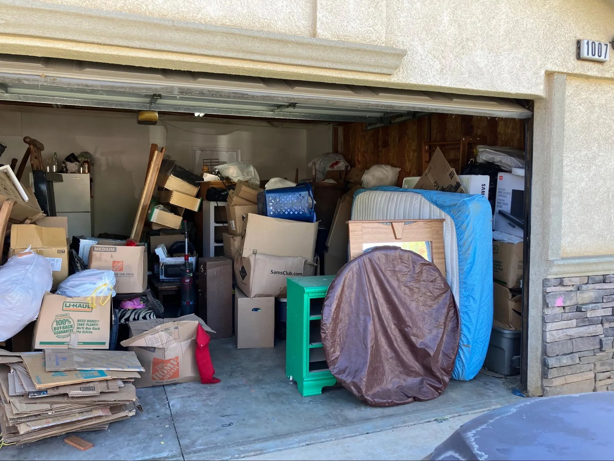 Old household appliances like a refrigerator or washing machine set out for junk removal by Dumpmasters.